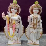 2 gold and red hindu deity figurines